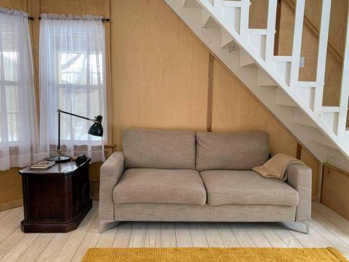 a living room with a couch and a staircase at Modern Cottage Two (The Lorca, Catskills) in Shandaken
