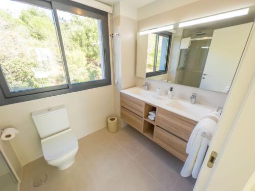 a bathroom with a sink and a toilet and a mirror at PENTHOUSE IN GOLDEN MILE in Marbella