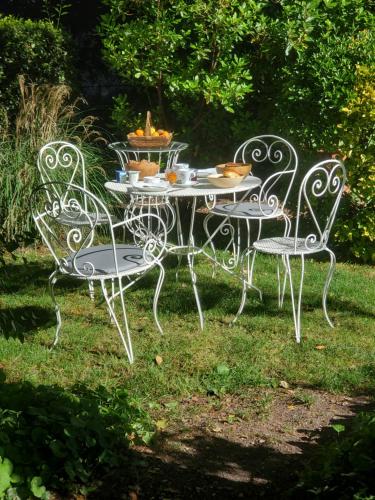 a table and two chairs with food on it at Logis des Tourelles in Cognac