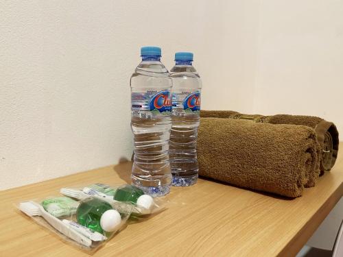 two bottles of water sitting on top of a table at Casa Feby Guest House in Bandung