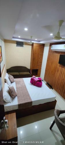 a bedroom with a large bed with purple sheets at Hotel Siddhi Vinayak in Jodhpur
