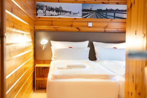 a bedroom with a large bed in a room at Hotel Kaliebe in Trassenheide