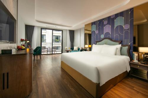 a bedroom with a large bed and a living room at MAY DE VILLE Lakeside Hotel in Hanoi