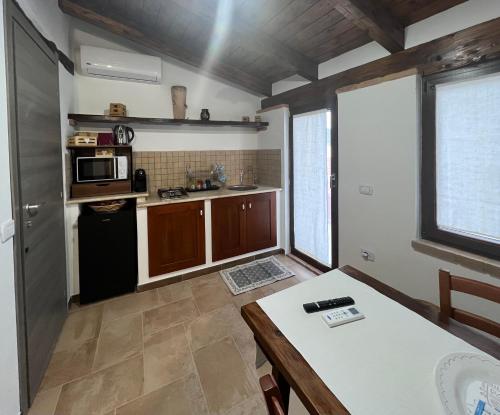 a small kitchen with a table and a microwave at Orani Guest House in Orani