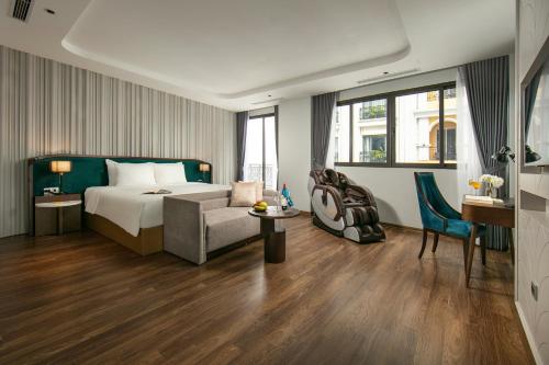 a hotel room with a bed and a couch and a table at MAY DE VILLE Lakeside Hotel in Hanoi