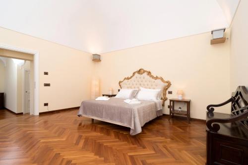 a bedroom with a large bed and a wooden floor at La finestra su Capri in Massa Lubrense