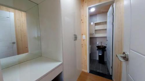 a bathroom with a shower and a walk in shower at Mirine Jeju in Jeju