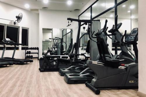 a gym with several treadmills and elliptical machines at Comfy-Concept Apartment @ B.Bintang (3min walk LRT, Lalaport, TimeSquare) in Kuala Lumpur