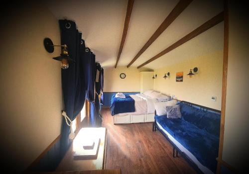 a room with a couch and a bed in it at Luxury Farm Breaks in Wisbech