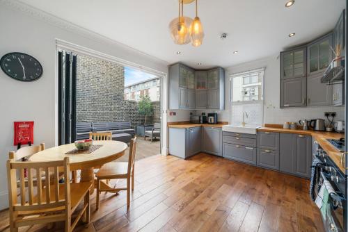 a kitchen with a table and a dining room at Royal Greenwich Hospitality in London