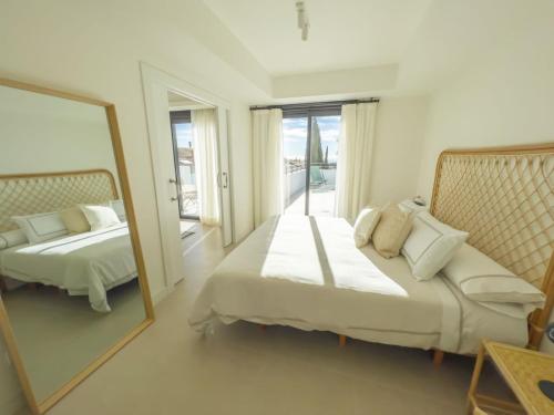 a bedroom with a mirror and a bed and a couch at PENTHOUSE IN GOLDEN MILE in Marbella