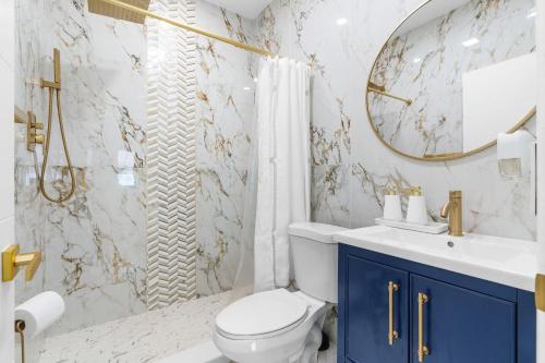 a bathroom with a toilet and a sink and a mirror at 316 Seascape Unit 2 in Hollywood