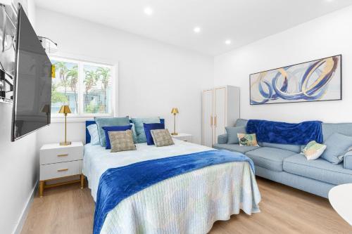 a bedroom with a blue bed and a couch at 316 Seascape Unit 2 in Hollywood