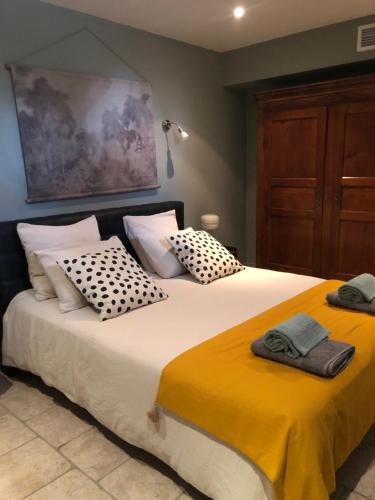 a bedroom with two beds with towels on them at Au bout du pré in Pézenas