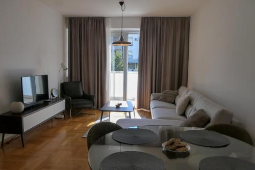 a living room with a couch and a table at Apartments Radovic in Podgorica