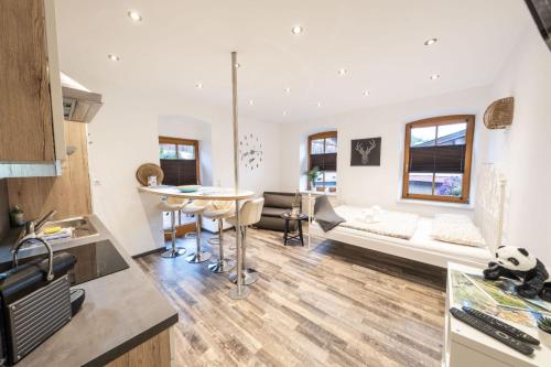 a kitchen and living room with a couch and a table at Ferienwohnung Annemarie in Mieders