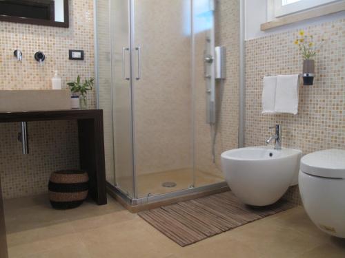 a bathroom with a shower and a toilet and a sink at B&B Sosta A Ponente in Matino