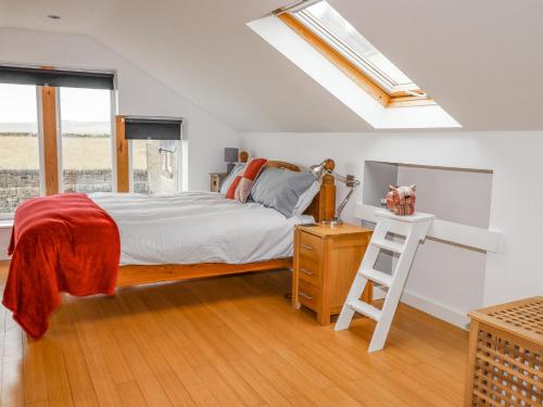 a bedroom with a bed and a skylight at Ash Tree Barn in Clayton
