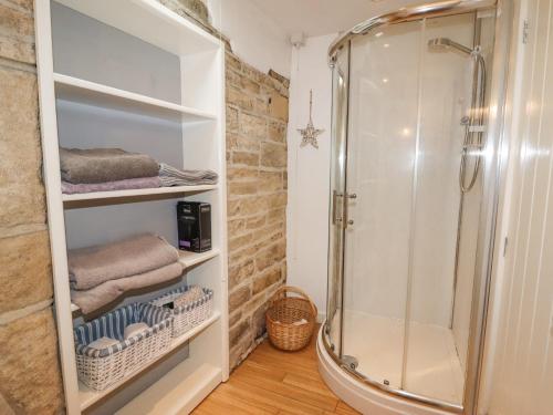 a bathroom with a shower and some towels at Ash Tree Barn in Clayton