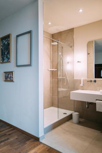 a bathroom with a shower and a sink at Hotel Amalia - Boutique Hotel in Landshut
