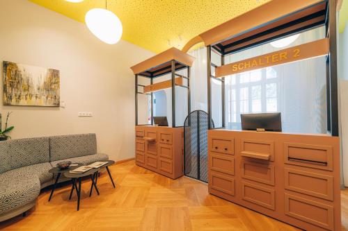 a salon with a bench and a table in a room at Hotel Amalia - Boutique Hotel in Landshut