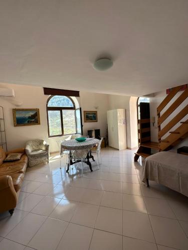 a living room with a table and a couch at Casa Paolina - casa vacanze in Capri