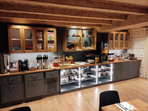 a kitchen with a counter with food on it at Riu Nere Mountain Hotel in Vielha
