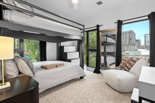 a bedroom with a loft bed and a couch at Skyline View, Pool, Gym, Balcony's, Walk to BWay! in Nashville