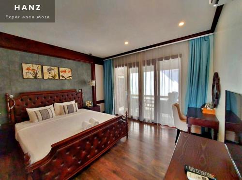 a bedroom with a large bed and a large window at Sunrise Hotel Luang Prabang MekongRiver in Luang Prabang