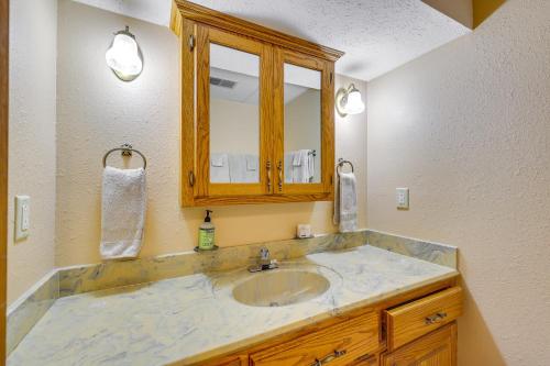 a bathroom with a sink and a mirror at Ozark Mountain View Retreat with Hot Tub! in Holiday Island