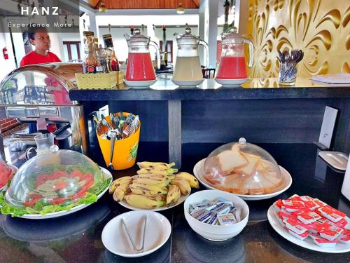 a counter with many plates of food on it at Sunrise Hotel Luang Prabang MekongRiver in Luang Prabang