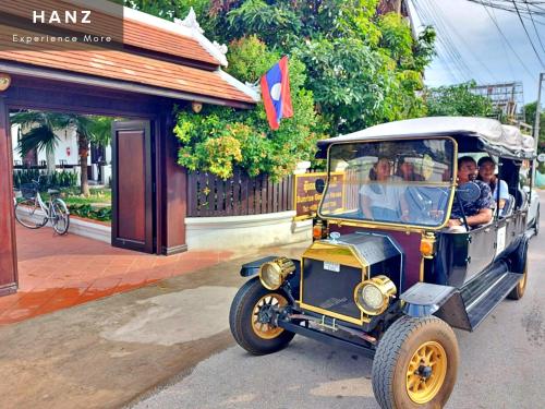 a group of people riding in an old car at Sunrise Hotel Luang Prabang MekongRiver in Luang Prabang