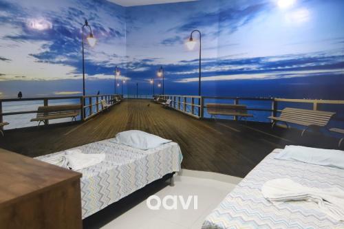 a room with two beds on a boardwalk at In Mare Bali Resort Beira Mar em Cotovelo by Qavi in Parnamirim