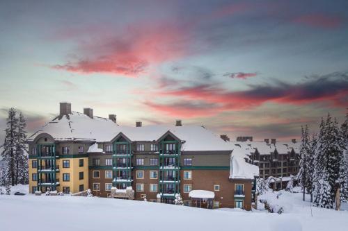 a building in the snow with a red sky at Constellation Residences in Truckee