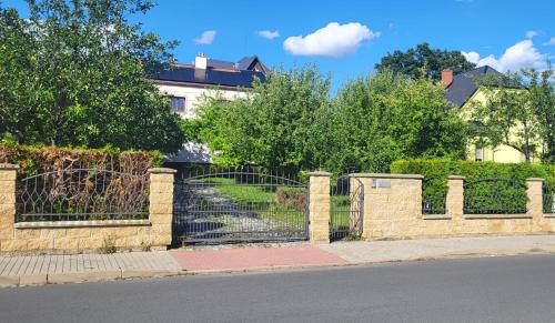 a fence with a gate in front of a house at Apartmán Husovka Bruntál - pokoj POLLY in Bruntál