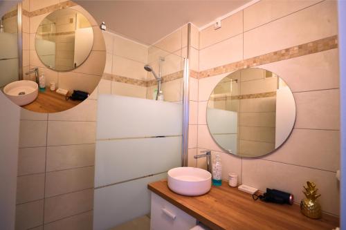 a bathroom with two mirrors and a sink at Amiens Chic - Baby Foot&Élégance in Amiens