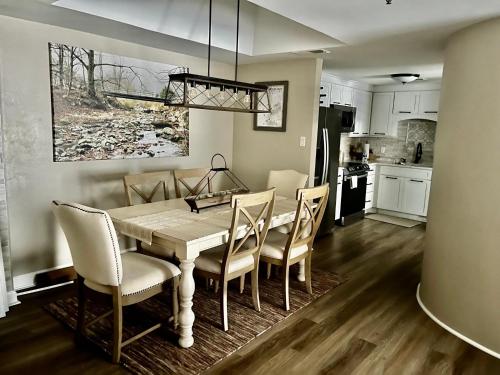 a kitchen and dining room with a table and chairs at On top of the world at Sugar Top Resort in Sugar Mountain