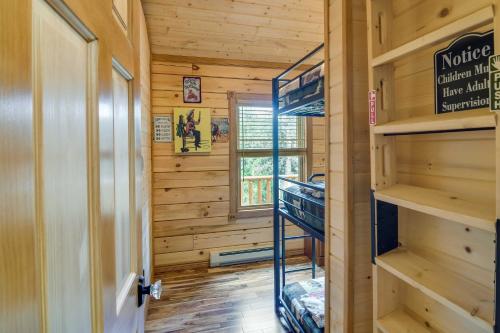 a tiny house with a ladder in a room at Private Hot Tub and Pond Conifer Log Cabin in Conifer