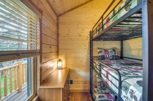 a bedroom with bunk beds in a log cabin at Private Hot Tub and Pond Conifer Log Cabin in Conifer