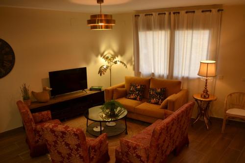 a living room with a couch and a tv at La Centralita de la Abuela in Segovia