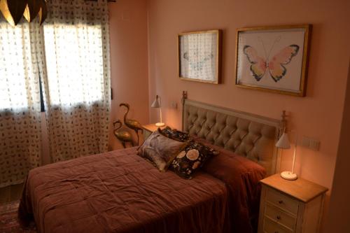a bedroom with a bed with a butterfly on the wall at La Centralita de la Abuela in Segovia