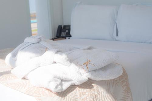 a pile of towels sitting on top of a bed at Karibao Resort Town in Playas