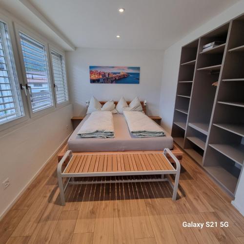 a small bedroom with a bed and shelves at Mountain-Lake Apartment 2 in Wilderswil