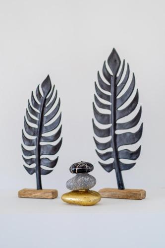 a group of three bird sculptures with a ring at K&D Central Suite in Sitia