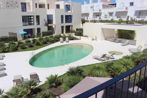 an overhead view of a swimming pool in front of a building at Seaside Fort House, T2 Tavira – Cabanas de Tavira in Cabanas de Tavira