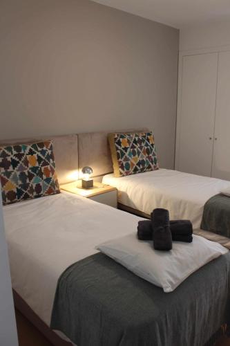 a room with two beds and a couch at Seaside Fort House, T2 Tavira – Cabanas de Tavira in Cabanas de Tavira