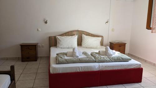 a bedroom with a bed with two pillows on it at 4 Seasons Villas 2 in Neokhórion