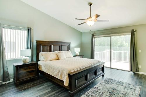 a bedroom with a bed and a ceiling fan at Spacious Goodyear Retreat - Walk to Wigwam! in Goodyear