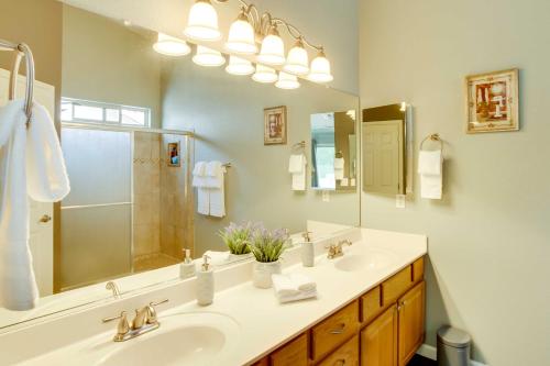 a bathroom with a sink and a large mirror at Spacious Goodyear Retreat - Walk to Wigwam! in Goodyear