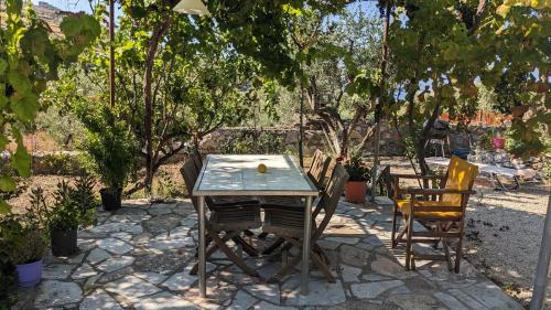 a table and chairs on a patio with trees at 4 Seasons Villas 2 in Neokhórion